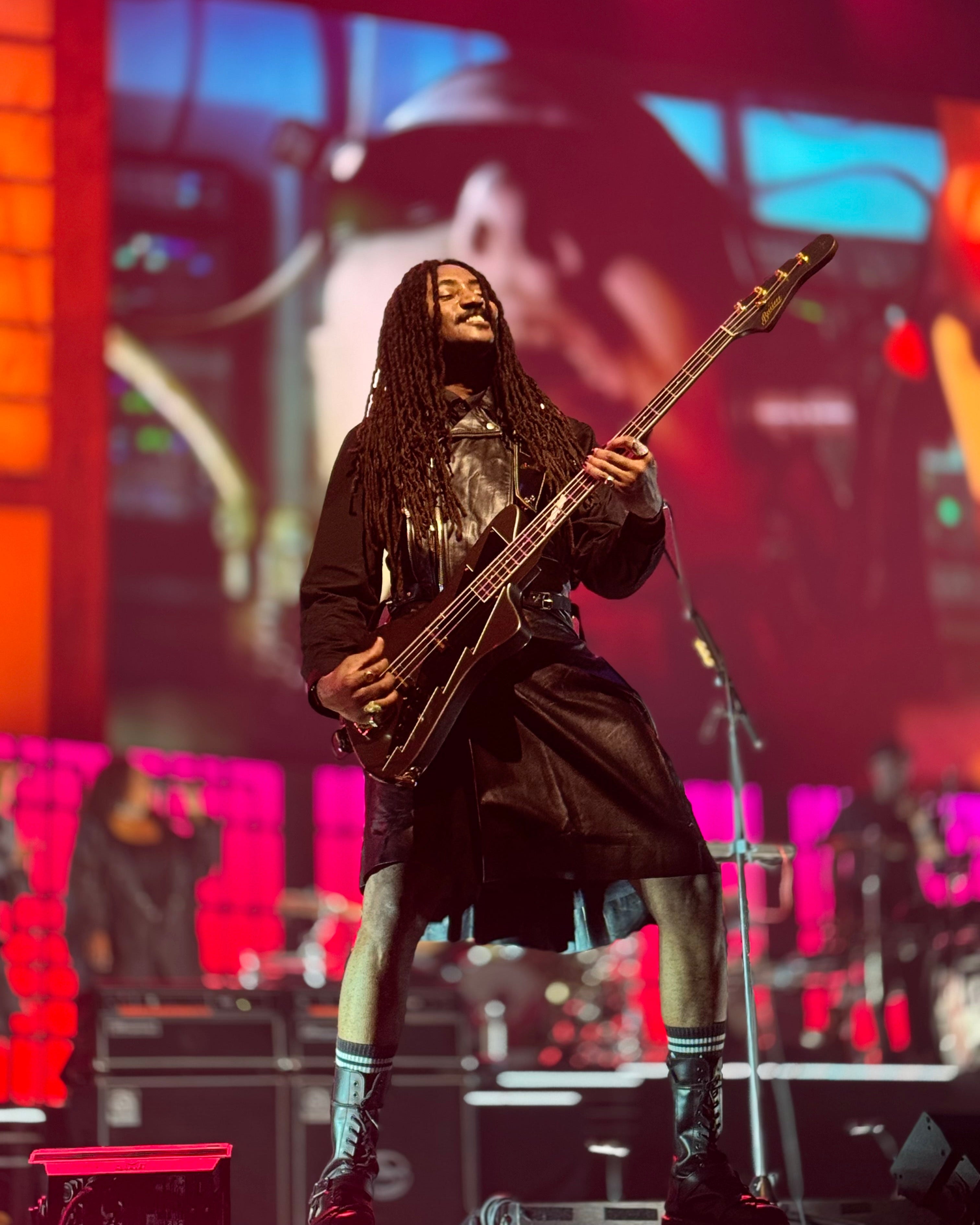 Seye Adelekan on stage with Gorillaz playing the signature Thunder Bass